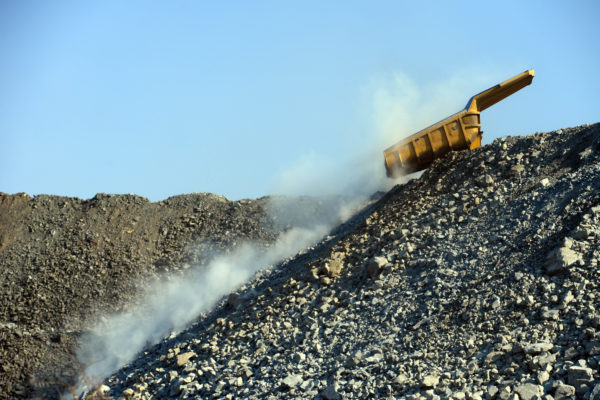A mining truck creates dust while offloading  in Motlhotlo rural village outside Mokopane, Limpopo. The village is a former version of itself, with patches of rubble from houses that were demolished when some were moved by Anglo American Platinum, to create way for mining activities. Few families remained behind and mining continue on their door step.