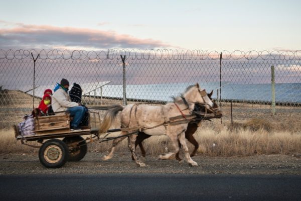 DE AAR, EMTHANJENI - 27 August 2021 - A horse cart carrying locals pass Globeleq's solar farm.Photo: Bram Lammers